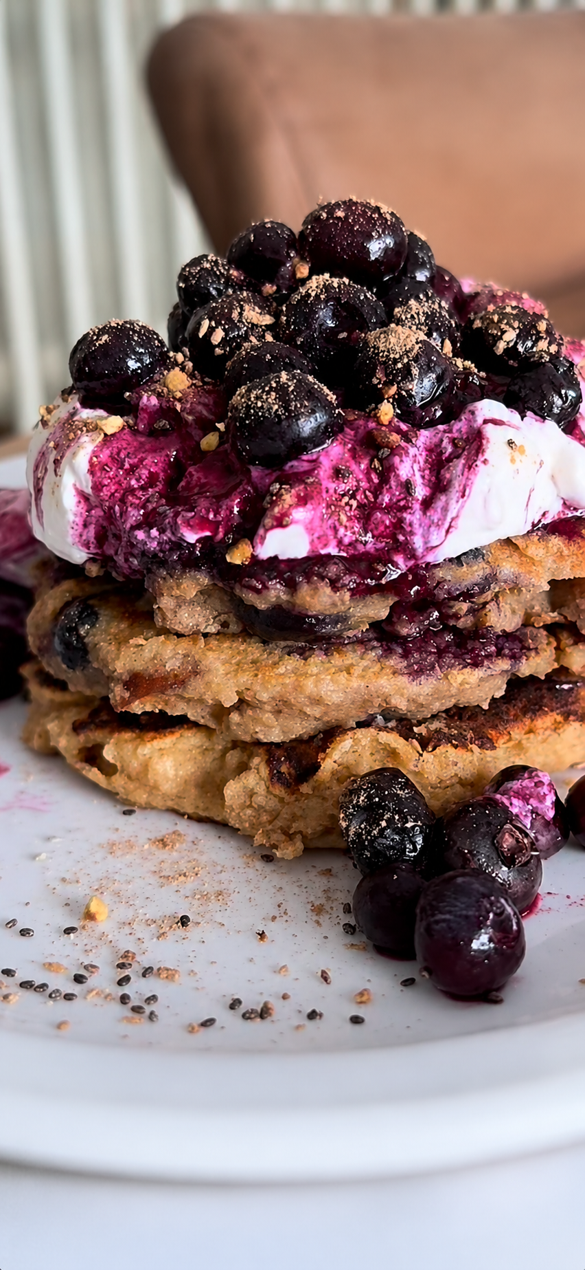 pancake stack with blueberries, apples, and banana